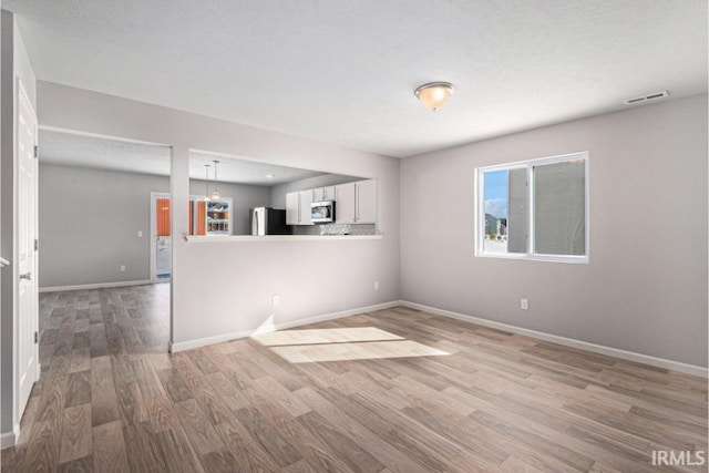 8247 Catberry Trl, Fort Wayne, IN 46804 - empty room with light wood-style floors and baseboards