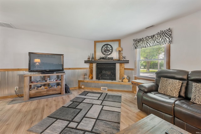 1591 W 100 N, Hartford City, IN 47348 - living area featuring a wainscoted wall, a fireplace with raised hearth, and wood finished floors