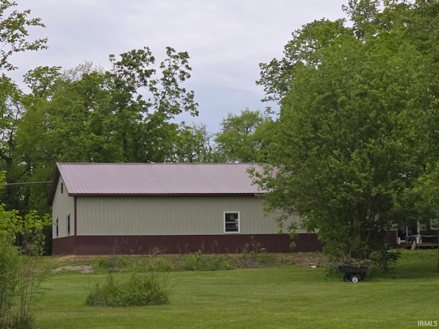 1591 W 100 N, Hartford City, IN 47348 - view of side of property featuring a pole building, a lawn, metal roof, and an outbuilding