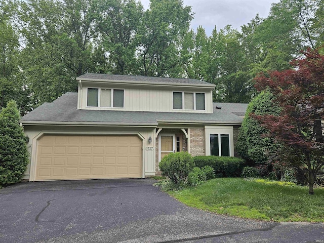 1327 Timberlake Rd, Evansville, IN 47710 - traditional home with driveway, a front lawn, an attached garage, and roof with shingles