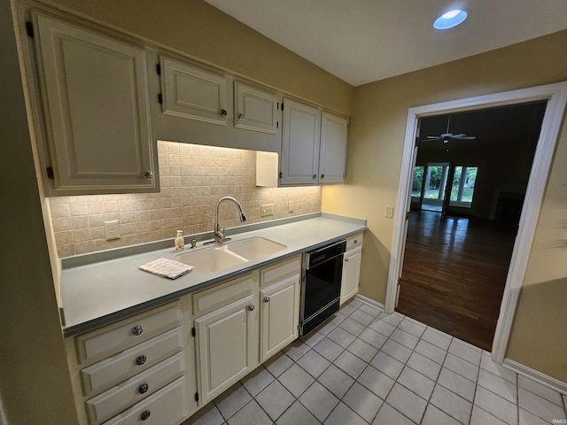 1327 Timberlake Rd, Evansville, IN 47710 - kitchen with black dishwasher, a sink, light tile patterned floors, backsplash, and light countertops