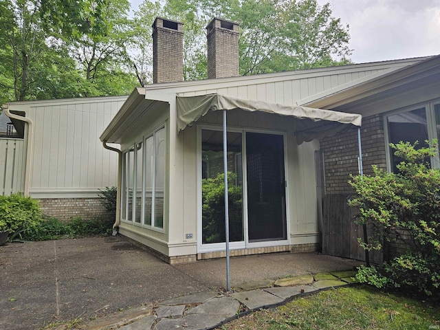 1327 Timberlake Rd, Evansville, IN 47710 - view of property exterior with a chimney and a patio