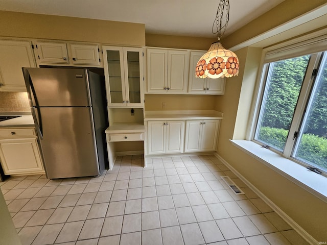 1327 Timberlake Rd, Evansville, IN 47710 - kitchen featuring freestanding refrigerator, healthy amount of natural light, light countertops, and pendant lighting