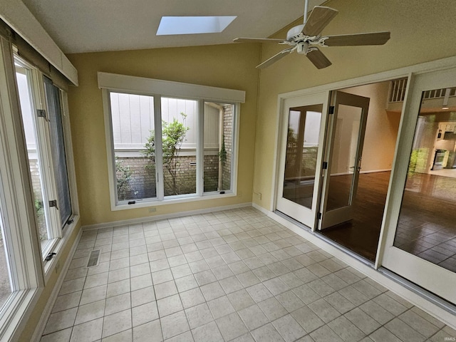 1327 Timberlake Rd, Evansville, IN 47710 - unfurnished sunroom featuring a skylight, vaulted ceiling, tile patterned floors, and baseboards