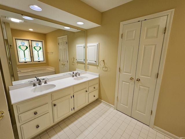 1327 Timberlake Rd, Evansville, IN 47710 - bathroom featuring baseboards, double vanity, recessed lighting, tile patterned flooring, and a garden tub