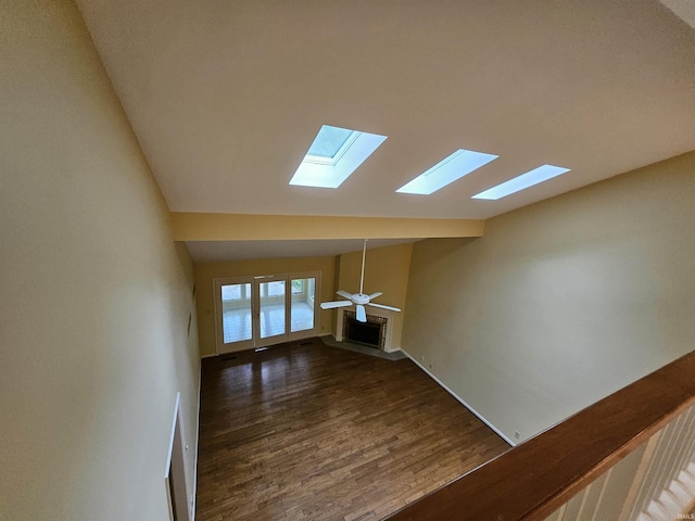 1327 Timberlake Rd, Evansville, IN 47710 - unfurnished living room with a skylight, dark wood finished floors, lofted ceiling, a fireplace, and baseboards