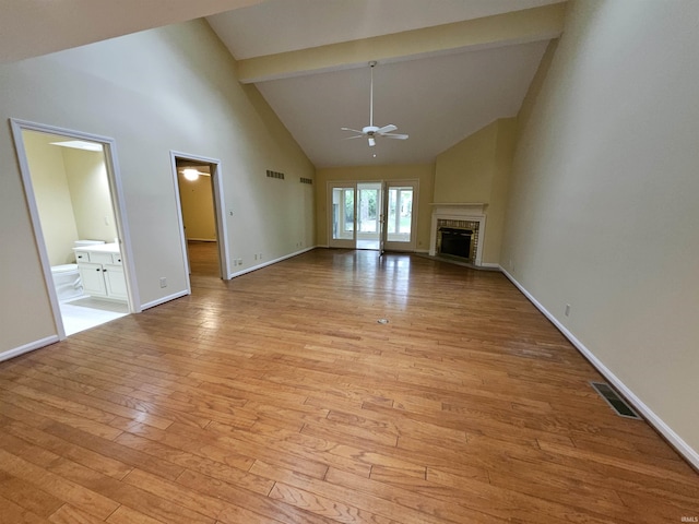 1327 Timberlake Rd, Evansville, IN 47710 - unfurnished living room featuring ceiling fan, high vaulted ceiling, light wood-style floors, beamed ceiling, and a brick fireplace