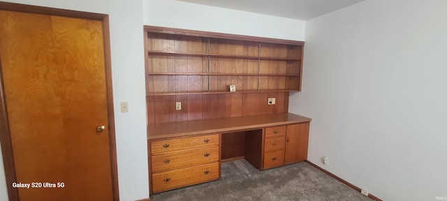 1202 N Sheridan Rd, Marion, IN 46952 - unfurnished office with built in desk, dark carpet, and baseboards