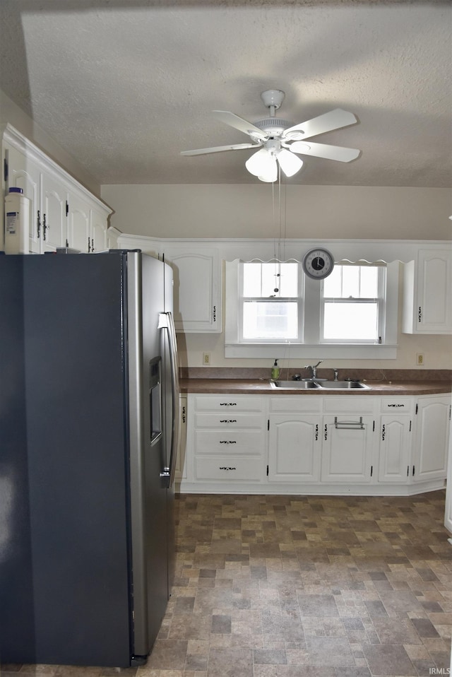 344 W 4th St, Jasper, IN 47546 - kitchen with stainless steel fridge, a sink, white cabinets, ceiling fan, and a textured ceiling