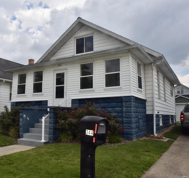 344 W 4th St, Jasper, IN 47546 - bungalow-style house featuring a front lawn and a chimney