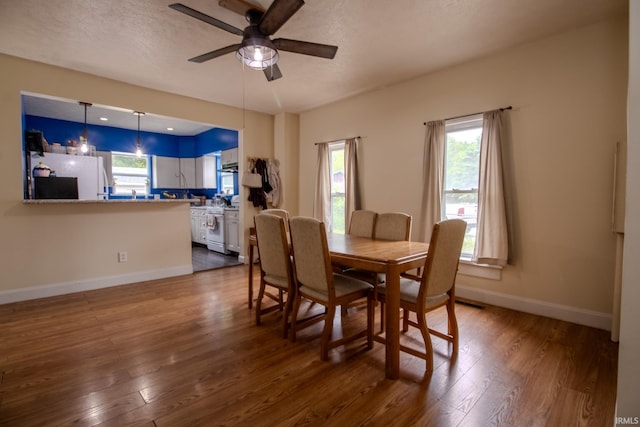 1113 Harrison St, Walkerton, IN 46574 - dining room with dark wood-type flooring, baseboards, ceiling fan, and a textured ceiling
