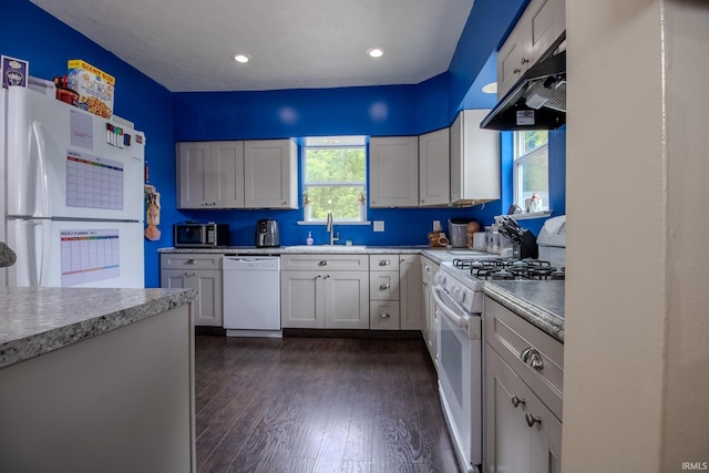 1113 Harrison St, Walkerton, IN 46574 - kitchen with white appliances, a sink, under cabinet range hood, dark wood-type flooring, and light countertops