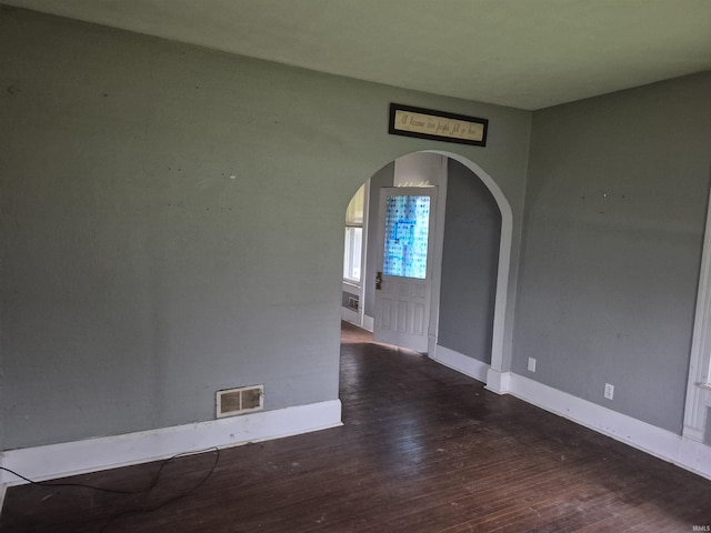 435 N Main St, Mulberry, IN 46058 - unfurnished room featuring arched walkways, wood finished floors, and baseboards