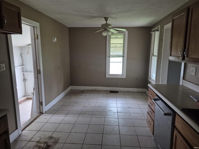 435 N Main St, Mulberry, IN 46058 - unfurnished dining area with ceiling fan, light tile patterned floors, baseboards, and a textured ceiling