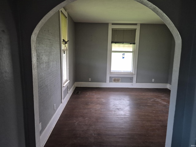 435 N Main St, Mulberry, IN 46058 - empty room featuring wood finished floors, arched walkways, and baseboards