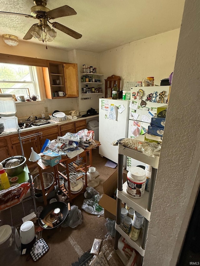 11 Water St, Huntington, IN 46750 - kitchen featuring freestanding refrigerator, open shelves, brown cabinetry, and a ceiling fan