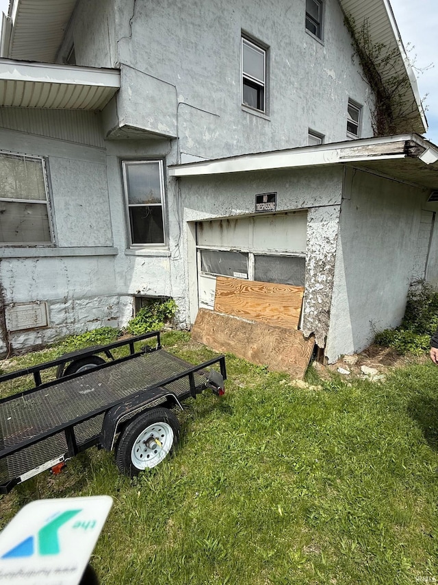 11 Water St, Huntington, IN 46750 - view of side of home with stucco siding and a lawn