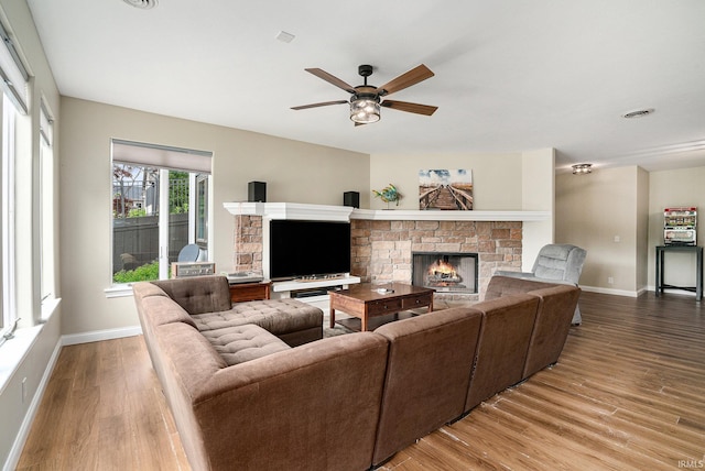 20870 N River Ridge Drive, Bristol, IN 46507 - living room with a stone fireplace, wood finished floors, baseboards, and a ceiling fan