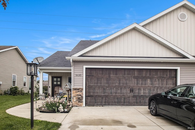 1635 Clover Creek Ln, Goshen, IN 46526 - view of front of home with a garage, concrete driveway, roof with shingles, stone siding, and board and batten siding