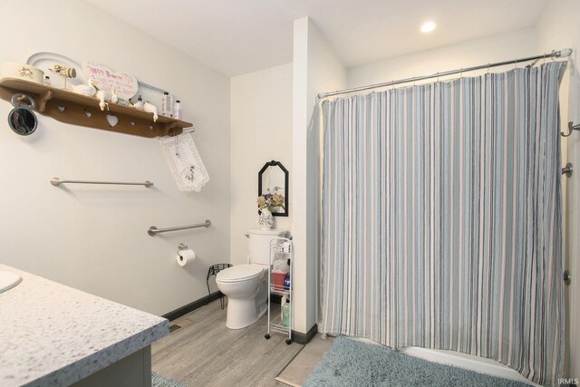 1635 Clover Creek Ln, Goshen, IN 46526 - bathroom featuring vanity, wood finished floors, toilet, curtained shower, and baseboards