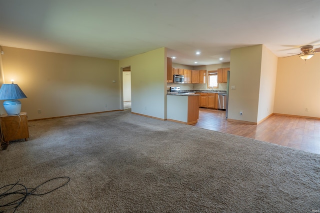 7768 S 100 W, North Judson, IN 46366 - unfurnished living room with light carpet, baseboards, recessed lighting, and ceiling fan