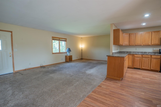7768 S 100 W, North Judson, IN 46366 - kitchen featuring baseboards, open floor plan, dark countertops, recessed lighting, and light wood-style flooring