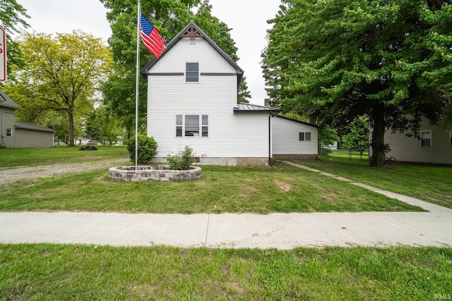 608 Union St, Lagrange, IN 46761 - view of side of home featuring a lawn, a standing seam roof, and metal roof