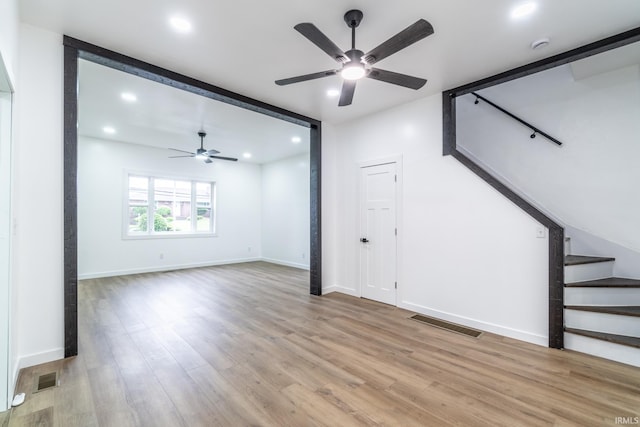 608 Union St, Lagrange, IN 46761 - unfurnished living room with ceiling fan, stairway, light wood finished floors, recessed lighting, and baseboards