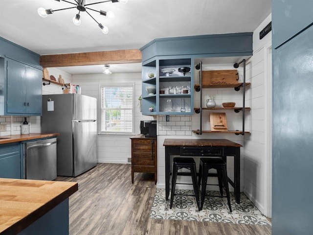 2728 E Dr, Fort Wayne, IN 46805 - kitchen featuring stainless steel appliances, blue cabinetry, wooden counters, wood finished floors, and open shelves