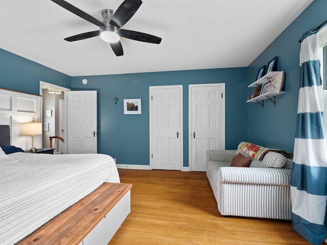 2728 E Dr, Fort Wayne, IN 46805 - bedroom with light wood finished floors, two closets, baseboards, and ceiling fan