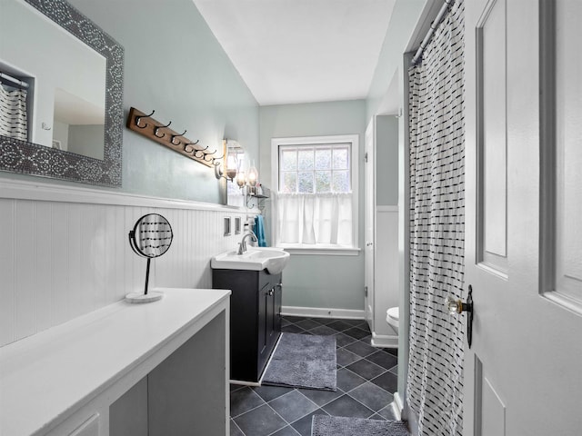 2728 E Dr, Fort Wayne, IN 46805 - bathroom featuring a wainscoted wall, tile patterned floors, toilet, and vanity