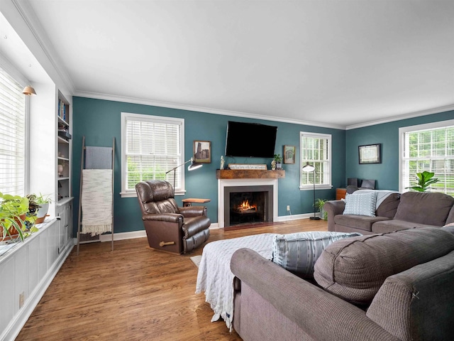 2728 E Dr, Fort Wayne, IN 46805 - living room featuring plenty of natural light, wood finished floors, a fireplace with flush hearth, and crown molding