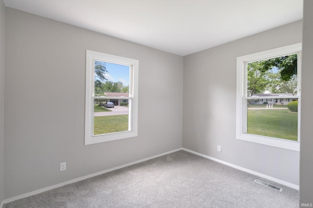 1813 Crescent Dr, Warsaw, IN 46580 - empty room with plenty of natural light, baseboards, and carpet flooring