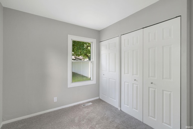 1813 Crescent Dr, Warsaw, IN 46580 - unfurnished bedroom with carpet floors, baseboards, and multiple closets