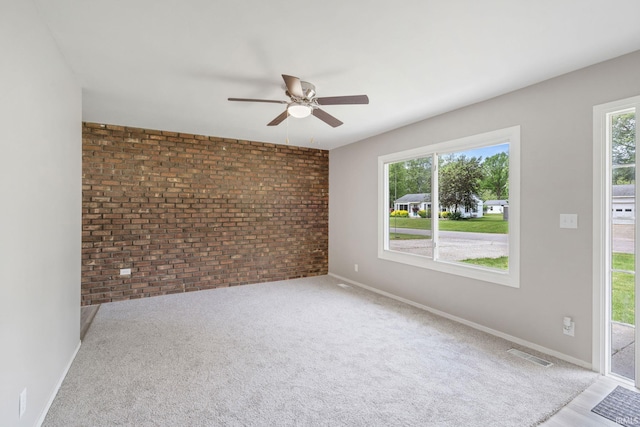 1813 Crescent Dr, Warsaw, IN 46580 - empty room with brick wall, a ceiling fan, and baseboards