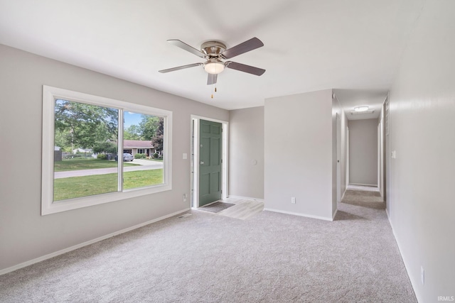 1813 Crescent Dr, Warsaw, IN 46580 - empty room with light carpet, ceiling fan, and baseboards