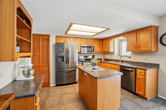 8427 Victoria Woods Pl, Fort Wayne, IN 46825 - kitchen featuring appliances with stainless steel finishes, a sink, dark countertops, and a kitchen island