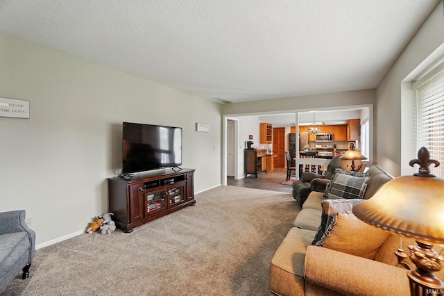 8427 Victoria Woods Pl, Fort Wayne, IN 46825 - living room featuring light colored carpet, baseboards, a chandelier, and a textured ceiling