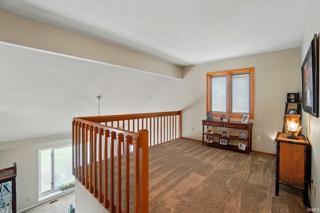 8427 Victoria Woods Pl, Fort Wayne, IN 46825 - hallway featuring carpet flooring, a textured ceiling, and baseboards