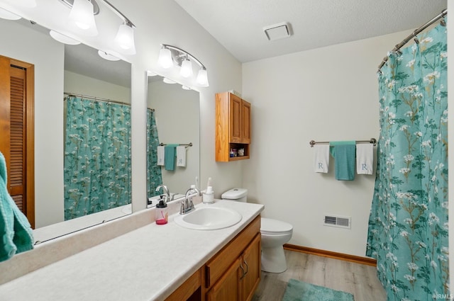 8427 Victoria Woods Pl, Fort Wayne, IN 46825 - full bathroom with wood finished floors, vanity, toilet, and baseboards