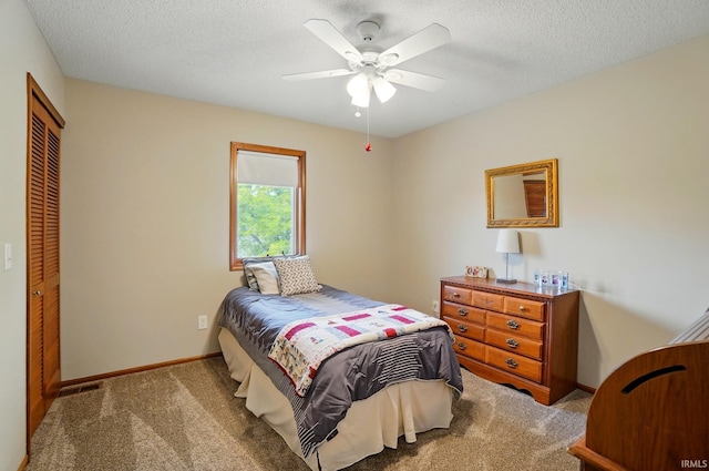 8427 Victoria Woods Pl, Fort Wayne, IN 46825 - bedroom featuring carpet flooring, a closet, baseboards, a textured ceiling, and a ceiling fan