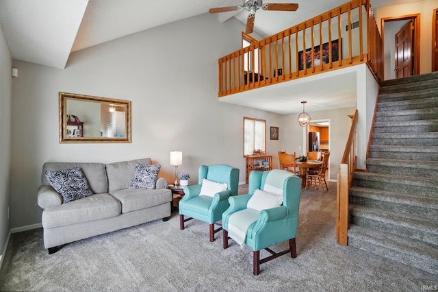 8427 Victoria Woods Pl, Fort Wayne, IN 46825 - living area with stairway, carpet floors, baseboards, a ceiling fan, and vaulted ceiling