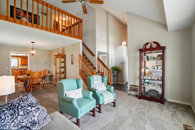 8427 Victoria Woods Pl, Fort Wayne, IN 46825 - living room featuring ceiling fan, high vaulted ceiling, carpet floors, stairway, and baseboards