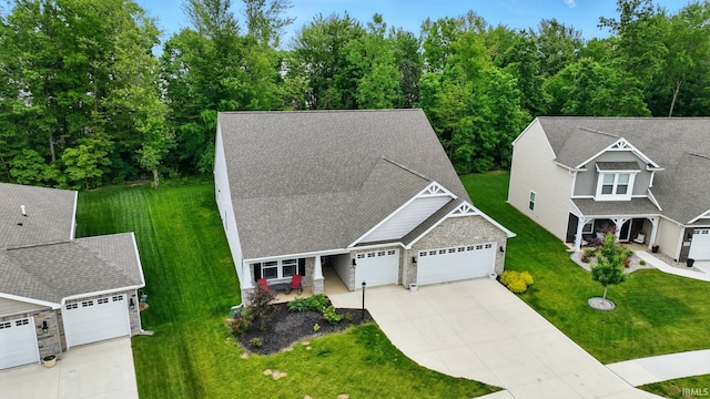 7756 Haven Blvd, Fort Wayne, IN 46804 - view of front of home with an attached garage, driveway, a front lawn, and roof with shingles
