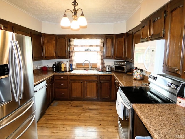105 Shawnee Dr, Bedford, IN 47421 - kitchen with stainless steel appliances, a sink, a textured ceiling, crown molding, and a chandelier