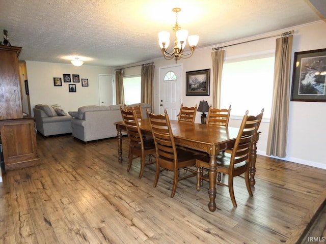 105 Shawnee Dr, Bedford, IN 47421 - dining room with hardwood / wood-style flooring, a chandelier, and a textured ceiling