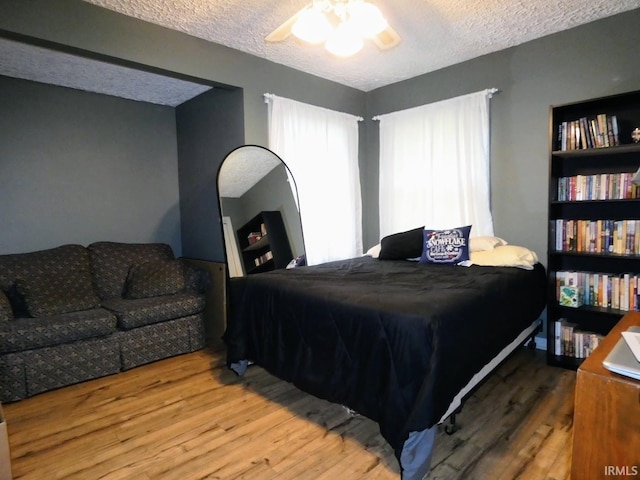 105 Shawnee Dr, Bedford, IN 47421 - bedroom with wood finished floors, a textured ceiling, and a ceiling fan