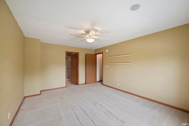 1544 Shining Armor Ln, West Lafayette, IN 47906 - unfurnished bedroom featuring baseboards, light colored carpet, a ceiling fan, and a walk in closet