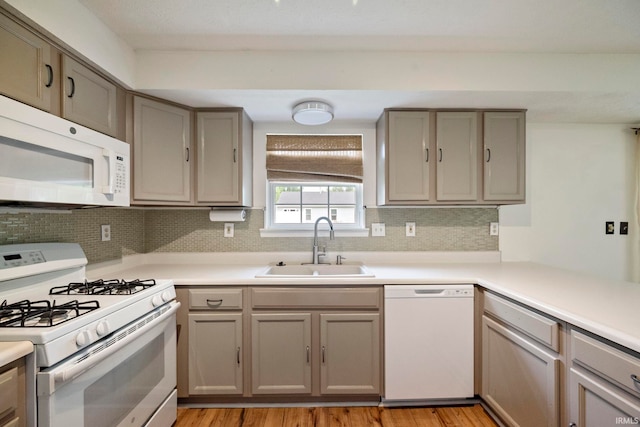 1544 Shining Armor Ln, West Lafayette, IN 47906 - kitchen featuring white appliances, a sink, gray cabinetry, backsplash, and light wood-style floors