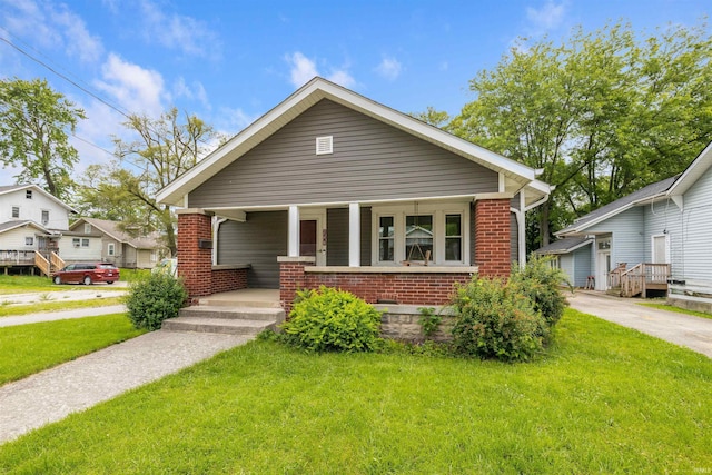 208 S Nichols Ave, Muncie, IN 47303 - bungalow featuring brick siding, a front yard, and a porch